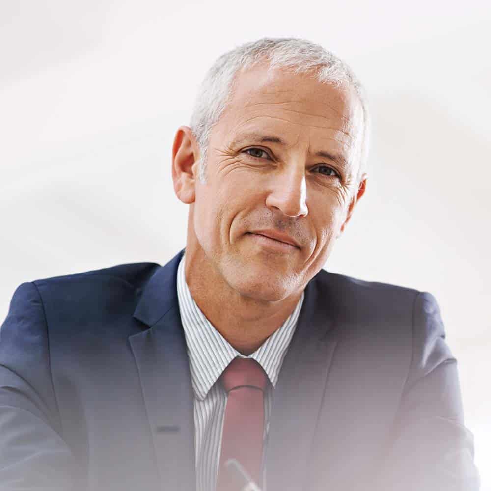 Confident mature man in business suit smiling, professional portrait.