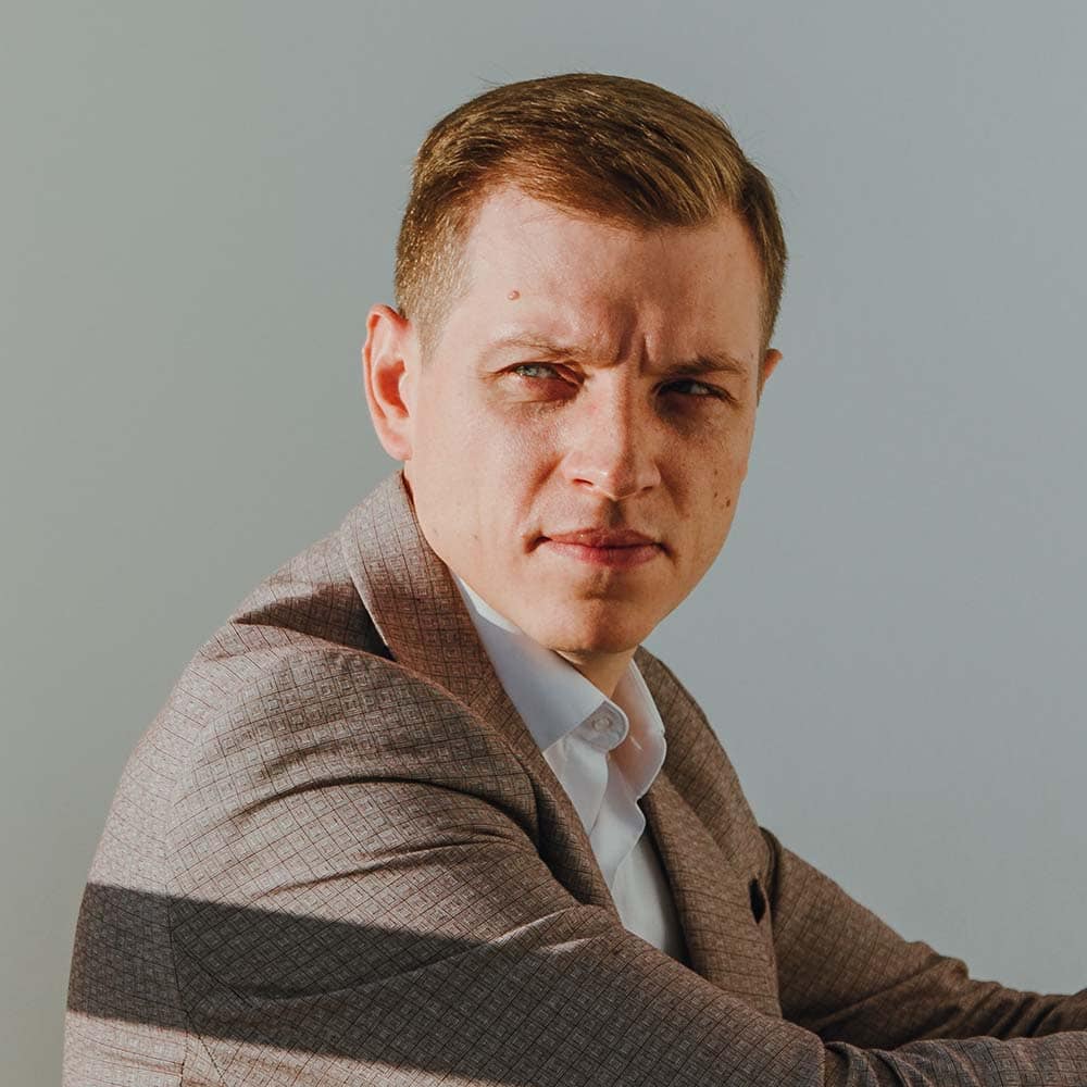 Business professional with serious expression in formal attire.