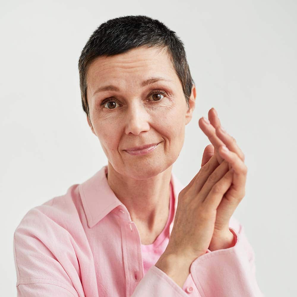 Woman practicing mindfulness meditation with hands in prayer pose.