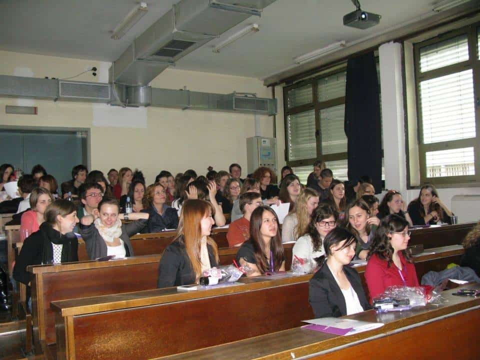 Students attending a lecture in a university classroom.